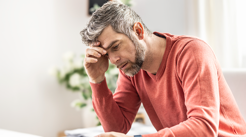 A young man is unhappy about the bad news that came to his smartphone.